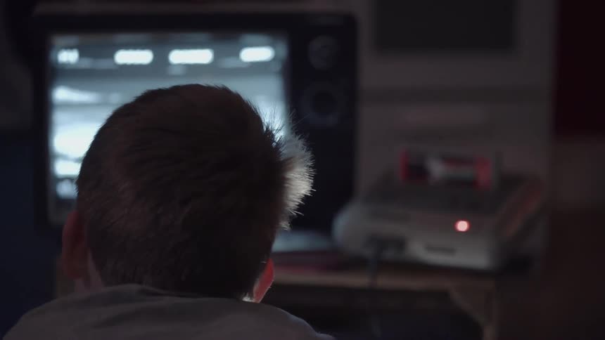 A boy is playing a video game on the television set