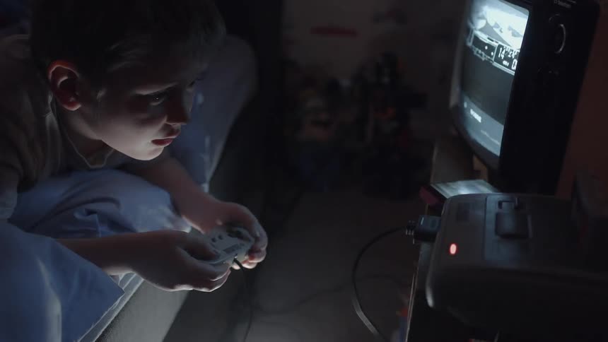 A boy plays a super nintendo that is vibrating