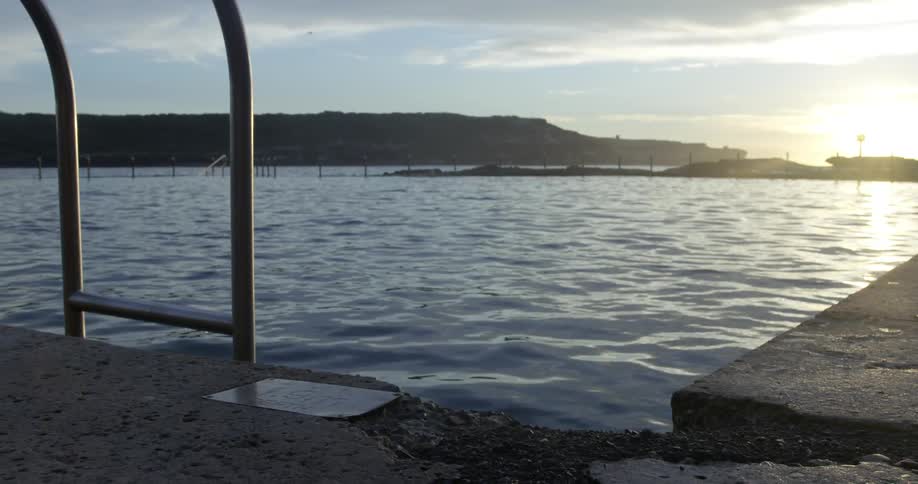 A ladder drops into a lake