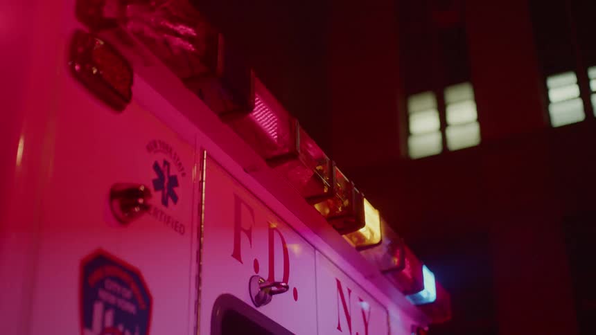 Ambulance lights flash in the night