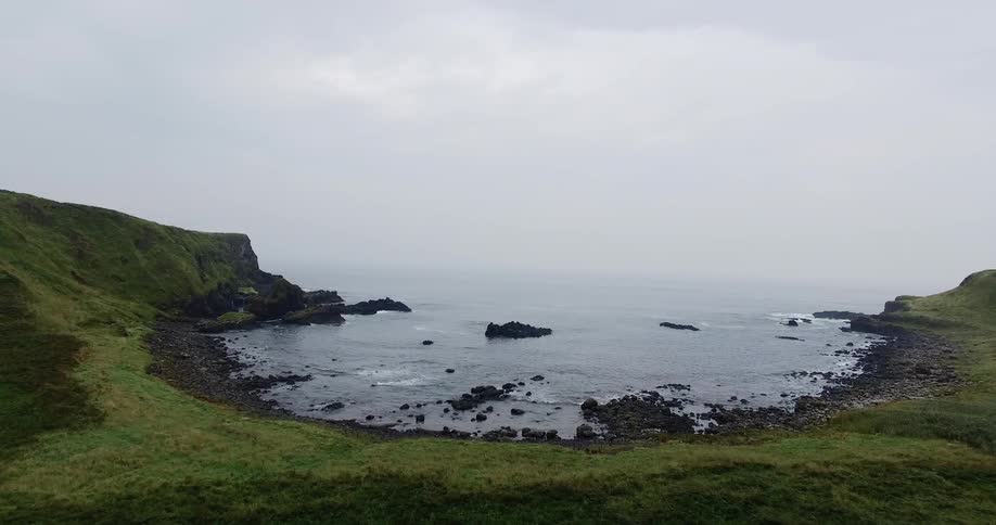 Past the shoreline is thick white clouds and fog