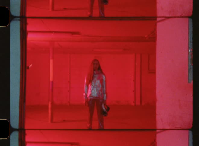 A woman stands in a room with flashing lights