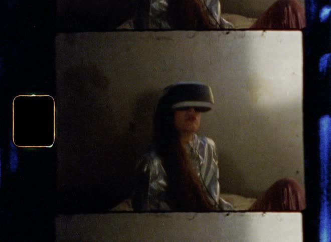 A woman is sitting in bed using virtual reality