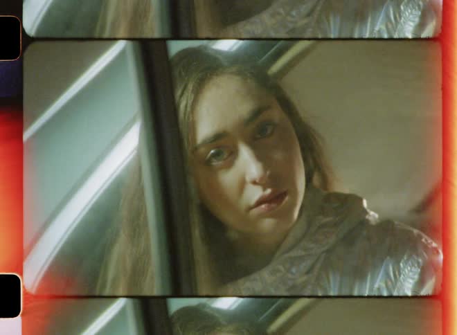 A woman is sitting in the back of the car leaning out