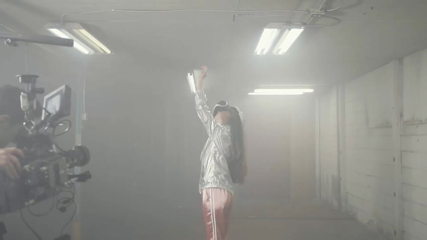 A woman is filmed while wearing a virtual reality headset