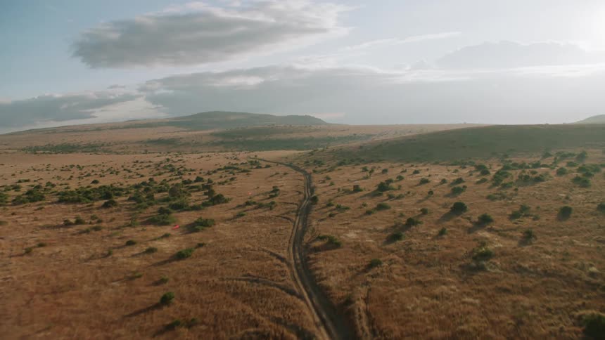 A trail runs through the hills and field