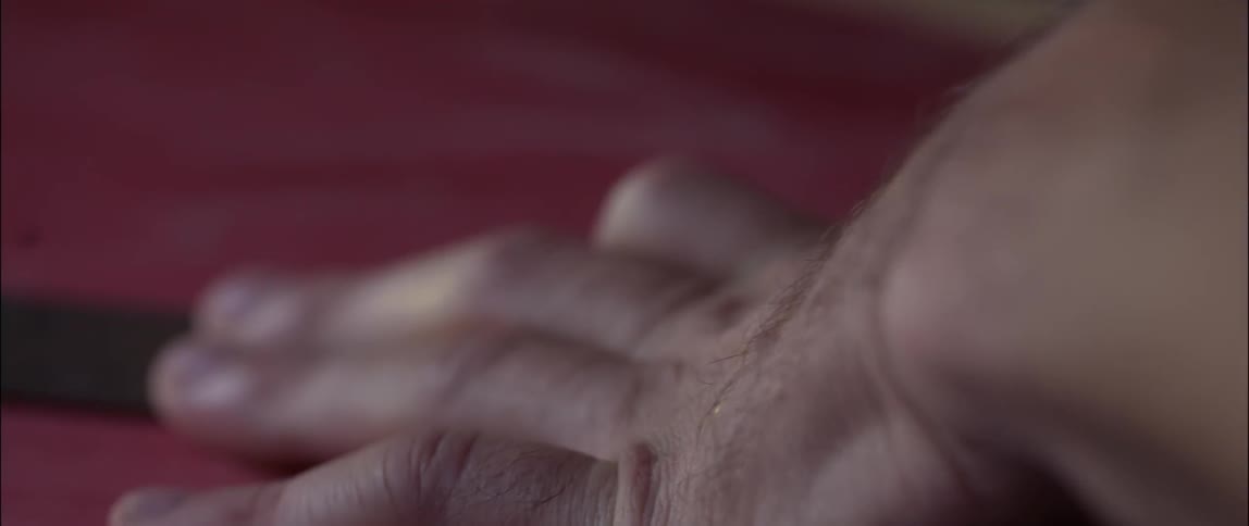 A man traces alongside a ruler