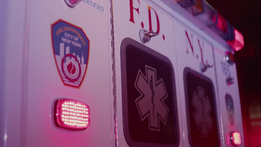 The ambulance is flashing at night