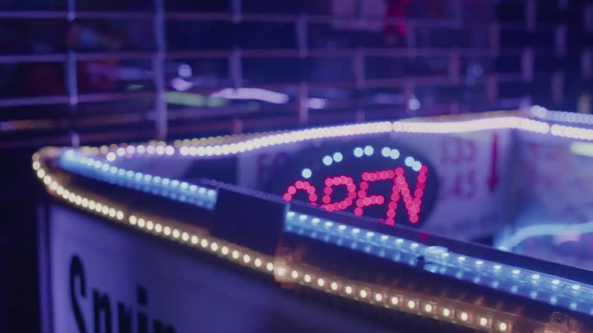 Lights and an open sign blink and shine