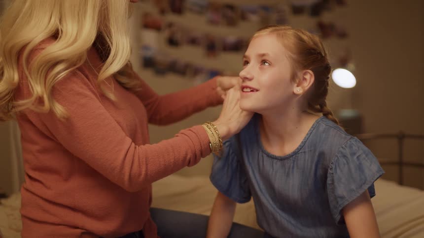 Mom braids her daughter's hair