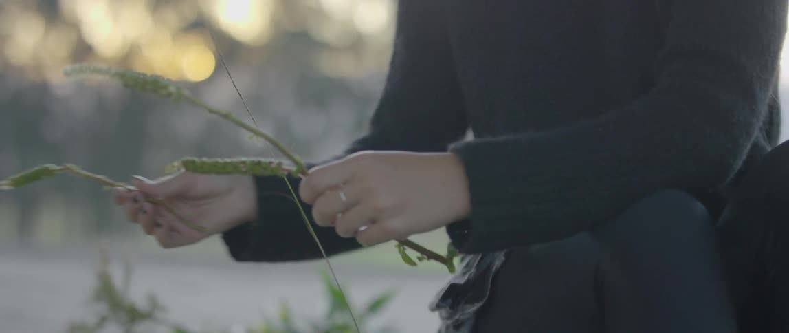 Woman picking weeds off the ground