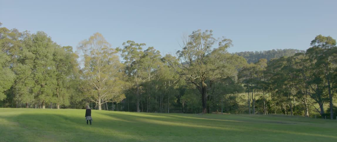 A woman walks across a field
