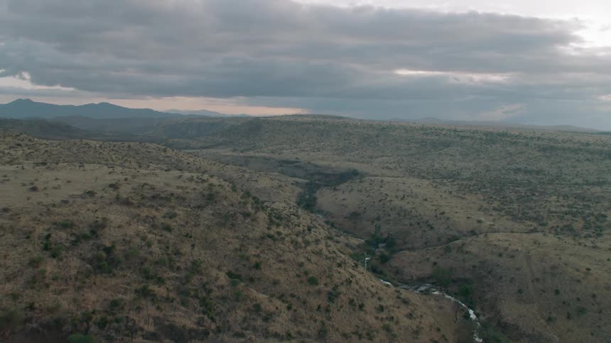 A river runs between a hilly landscape