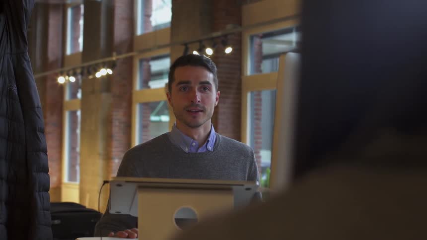Two employees talk in an office