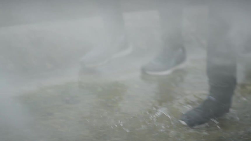 A group walks through the steam and water