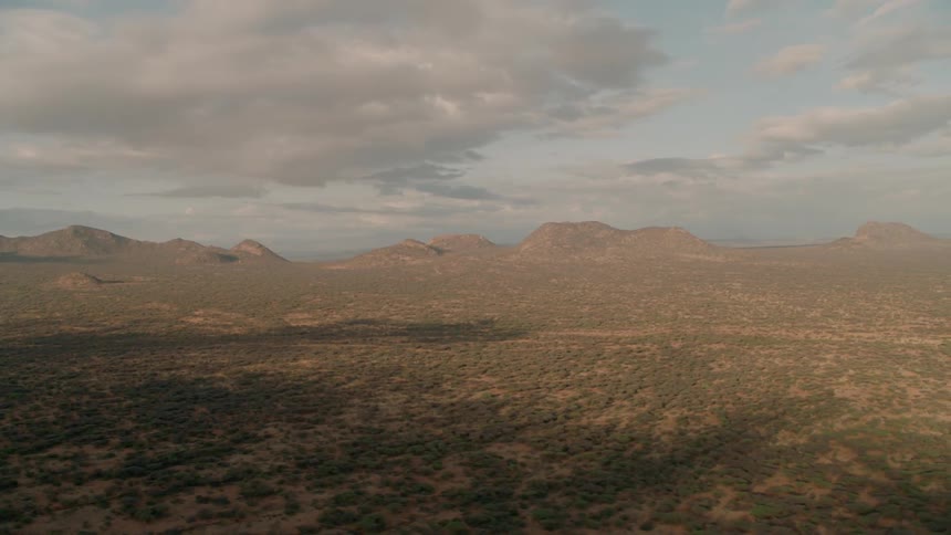 Clouds are hovering over a desert landscape during the day