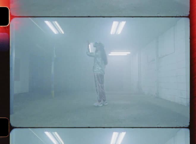 A woman is using a virtual reality headset in a foggy room