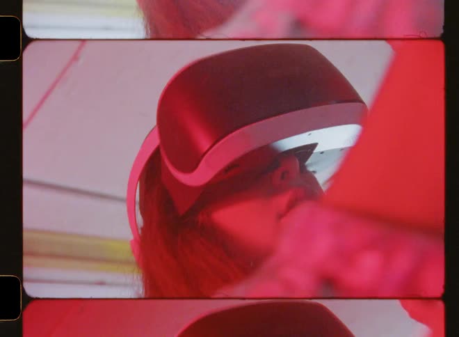 Woman wearing virtual reality headset in room with flashing lights