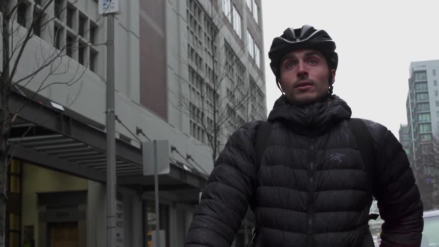 A man is standing out on the street of the city