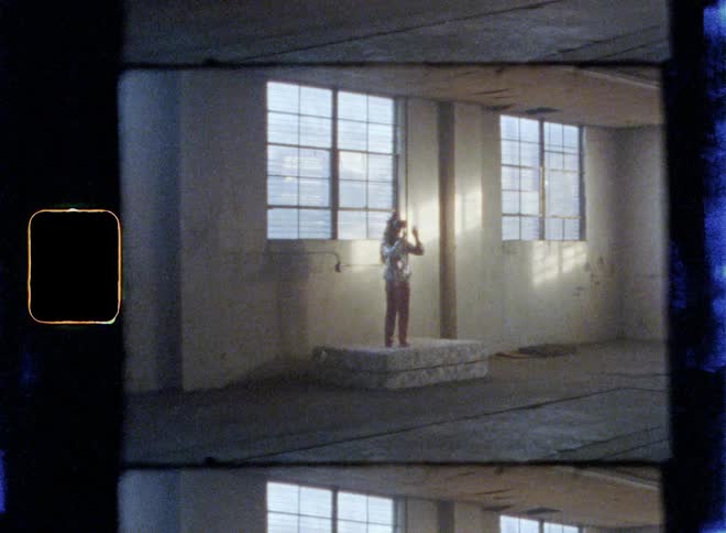 A woman is standing on a bed using a virtual reality headset