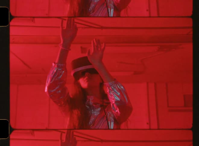 A woman wearing vr glasses feels around in a strobing room