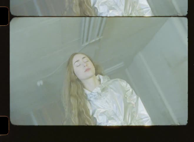 A woman walks in a room with flashing lights
