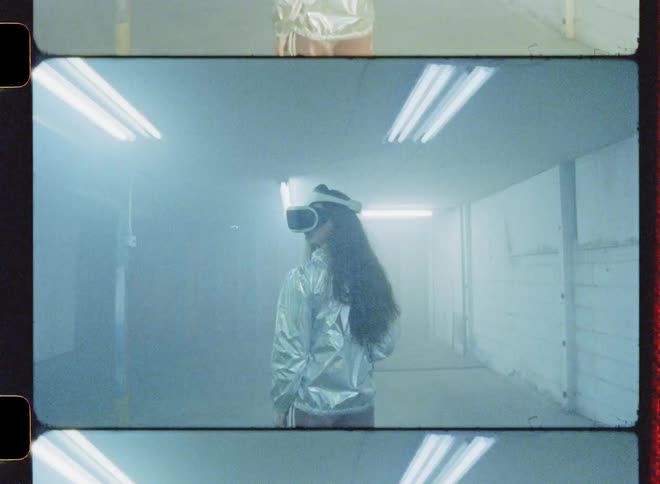A woman is standing inside an abandoned warehouse wearing a vr headset