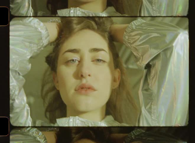 The strobe lights flash fast on the woman