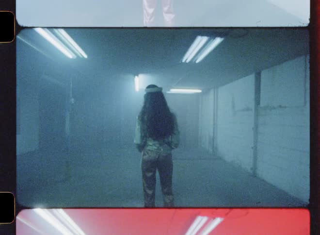 A woman wears a virtual reality headset while the lights flash