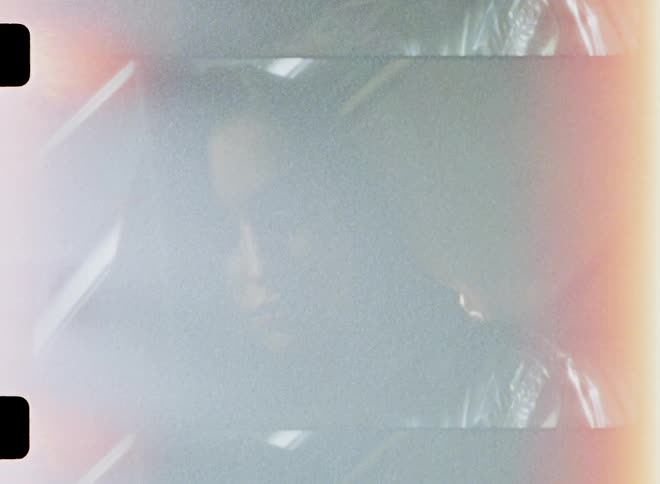 A woman sits in the back seat of a parked car