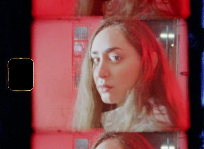 A woman is standing in standing in a room with flashing lights