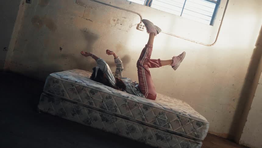 Girl is laying on back and moving hands and legs while wearing virtual reality headset