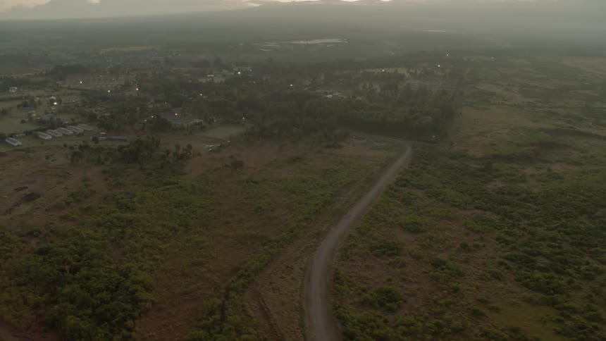 The long green fields below lead to a town in the center