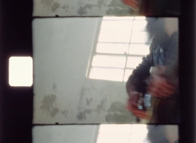A man plays guitar inside an old building