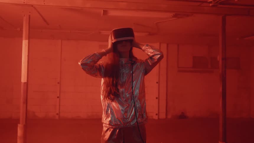 Girls uses virtual reality glasses as a flashing light blinks