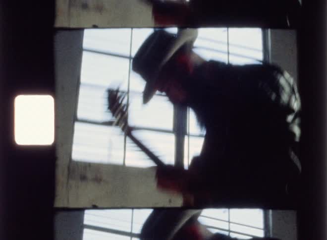 A man is swaying his guitar around as he plays