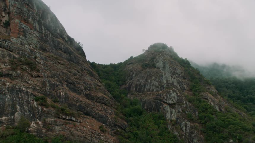 Clouds pass and hang above the stone mountains