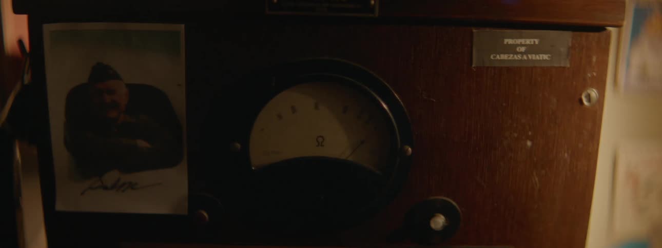 A photograph of a man in uniform hangs next to a dial