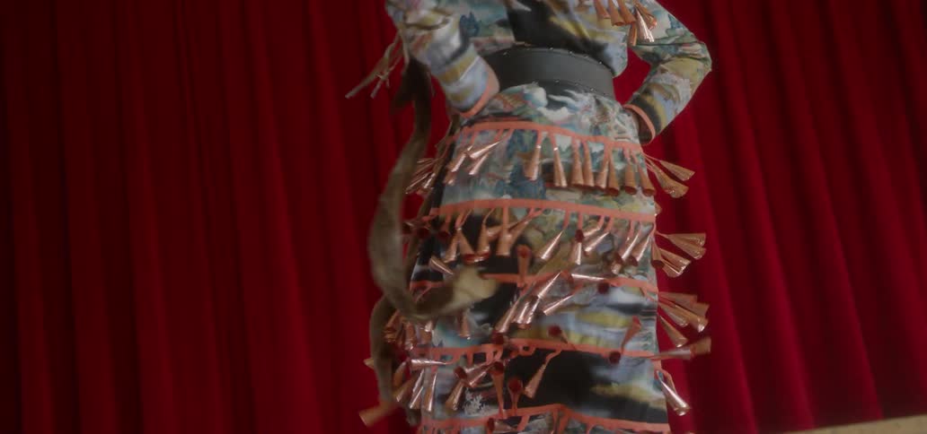 A woman is dancing in a colorful costume