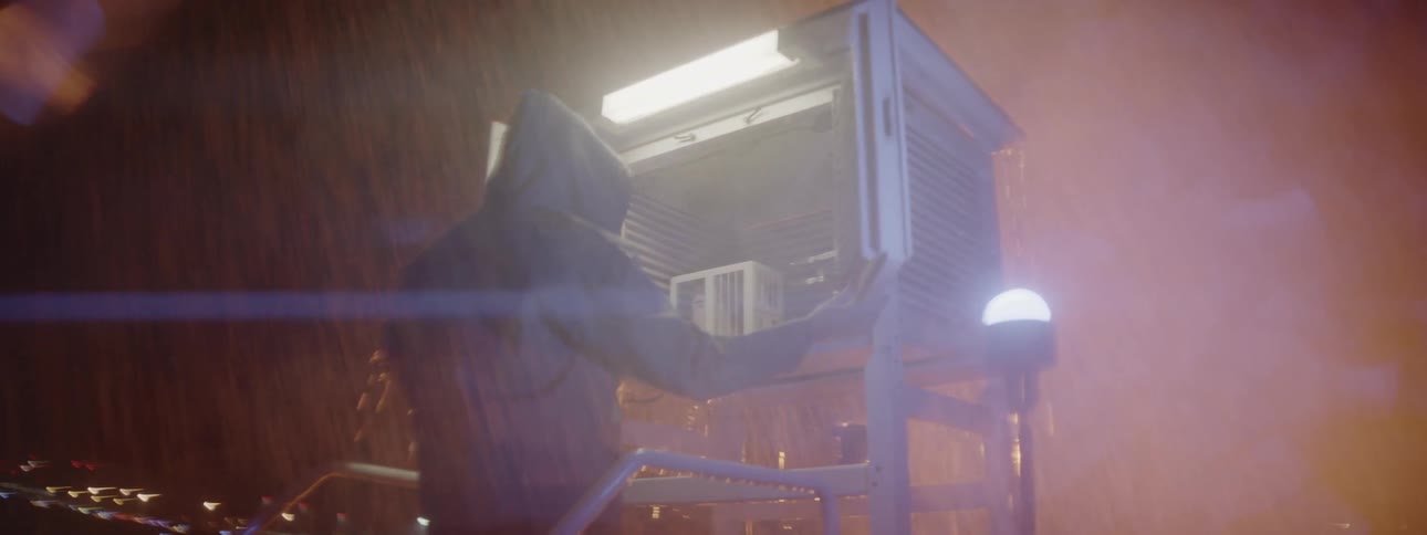 A man opens a cabinet in the pouring rain