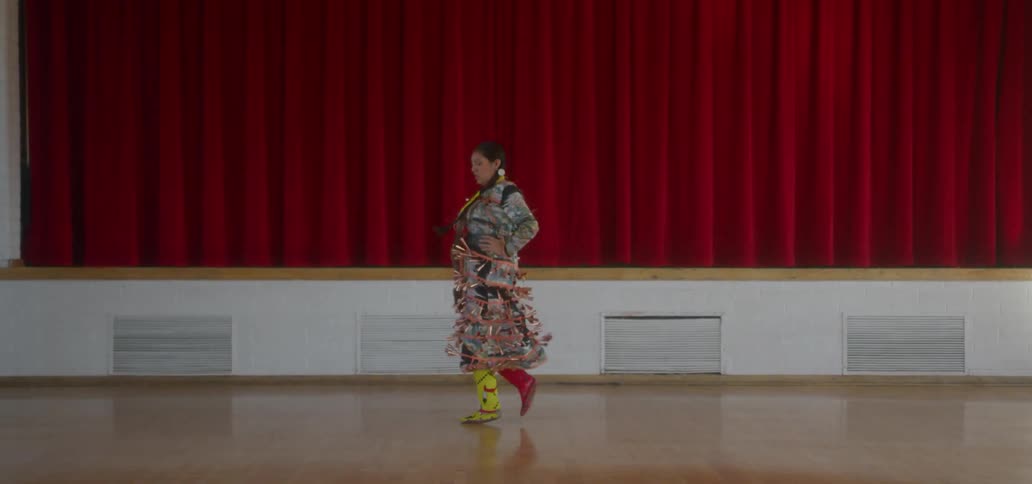 A woman is dancing on the auditorium floor