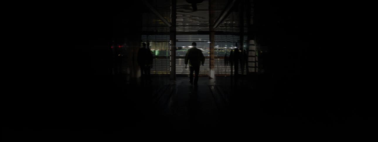 Man walks in a dark hallway