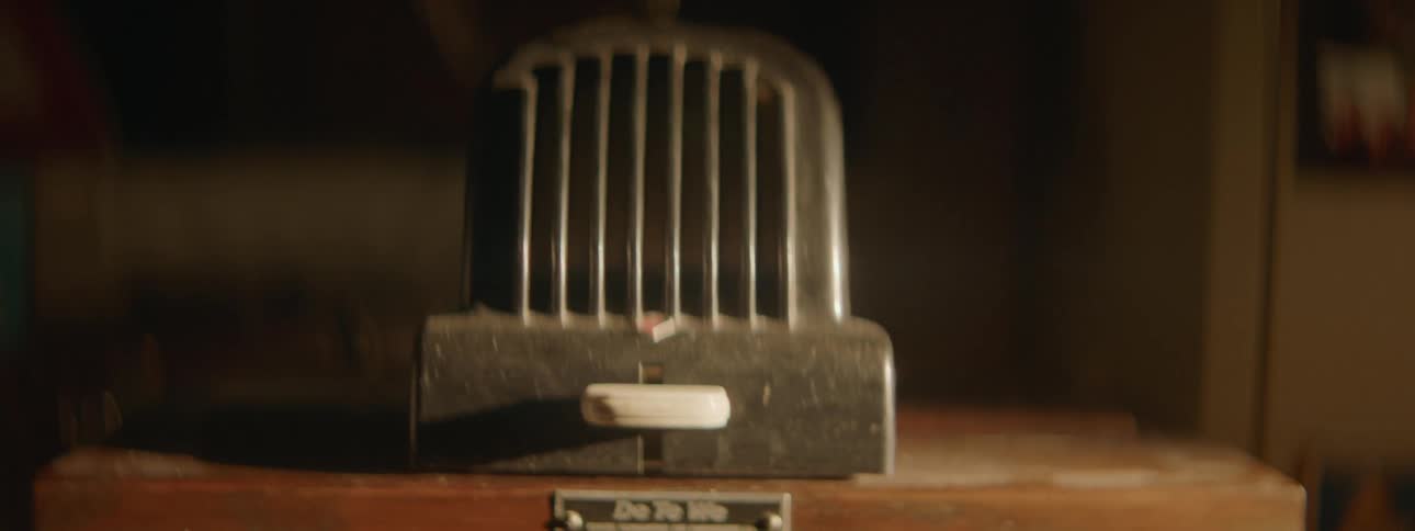 A metal instrument with a knob sits on the counter