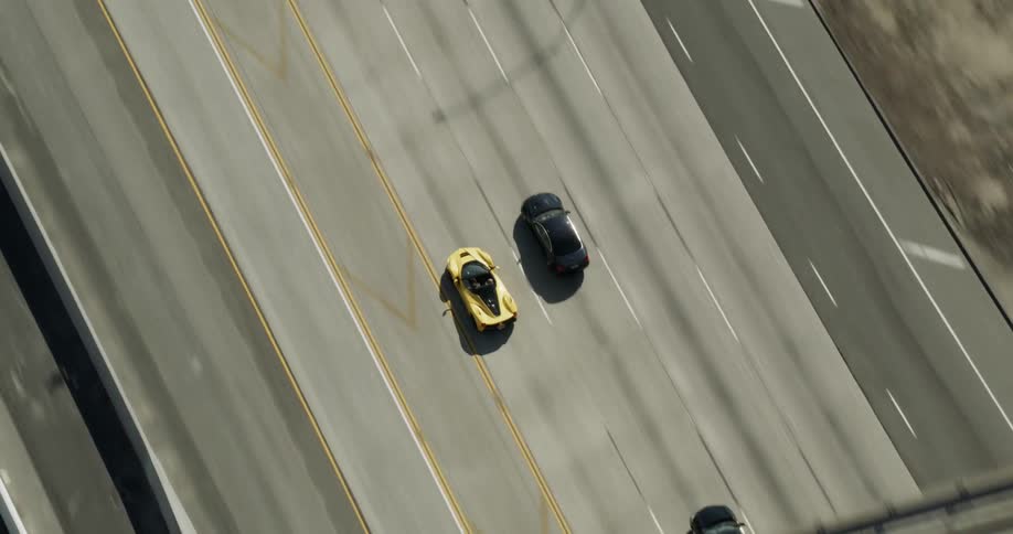 Aerial view of a Lamborghini racing down a freeway