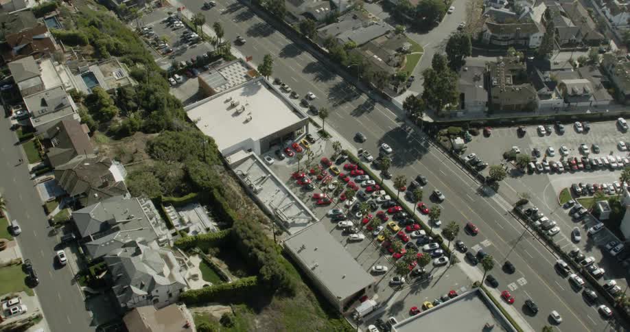 Cars drive on a city street