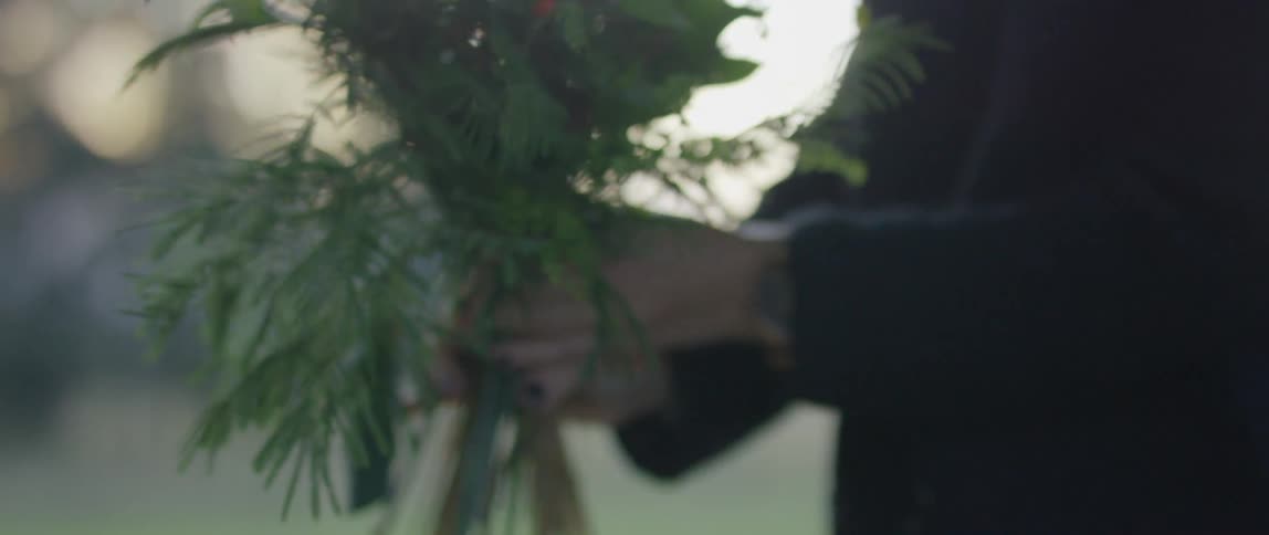 A woman is holding flowers