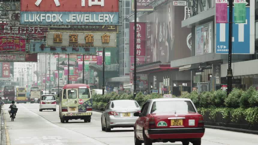 Vehicles travel down a city street