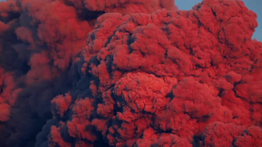Red mushroom clouds plume into the air