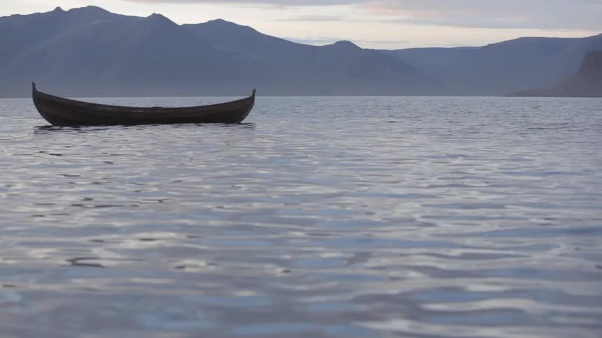 A small boat floats on the water