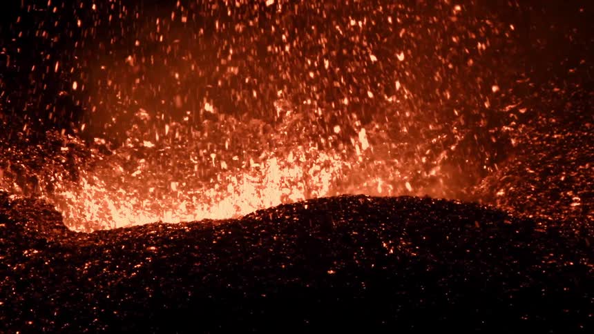Close-up of a volcano erupting at night